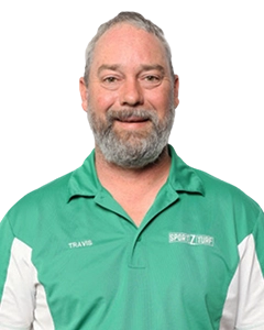 Travis McMeekin, Sportzturf owner, wearing a green Sportzturf polo shirt, showcasing expertise in synthetic turf solutions.